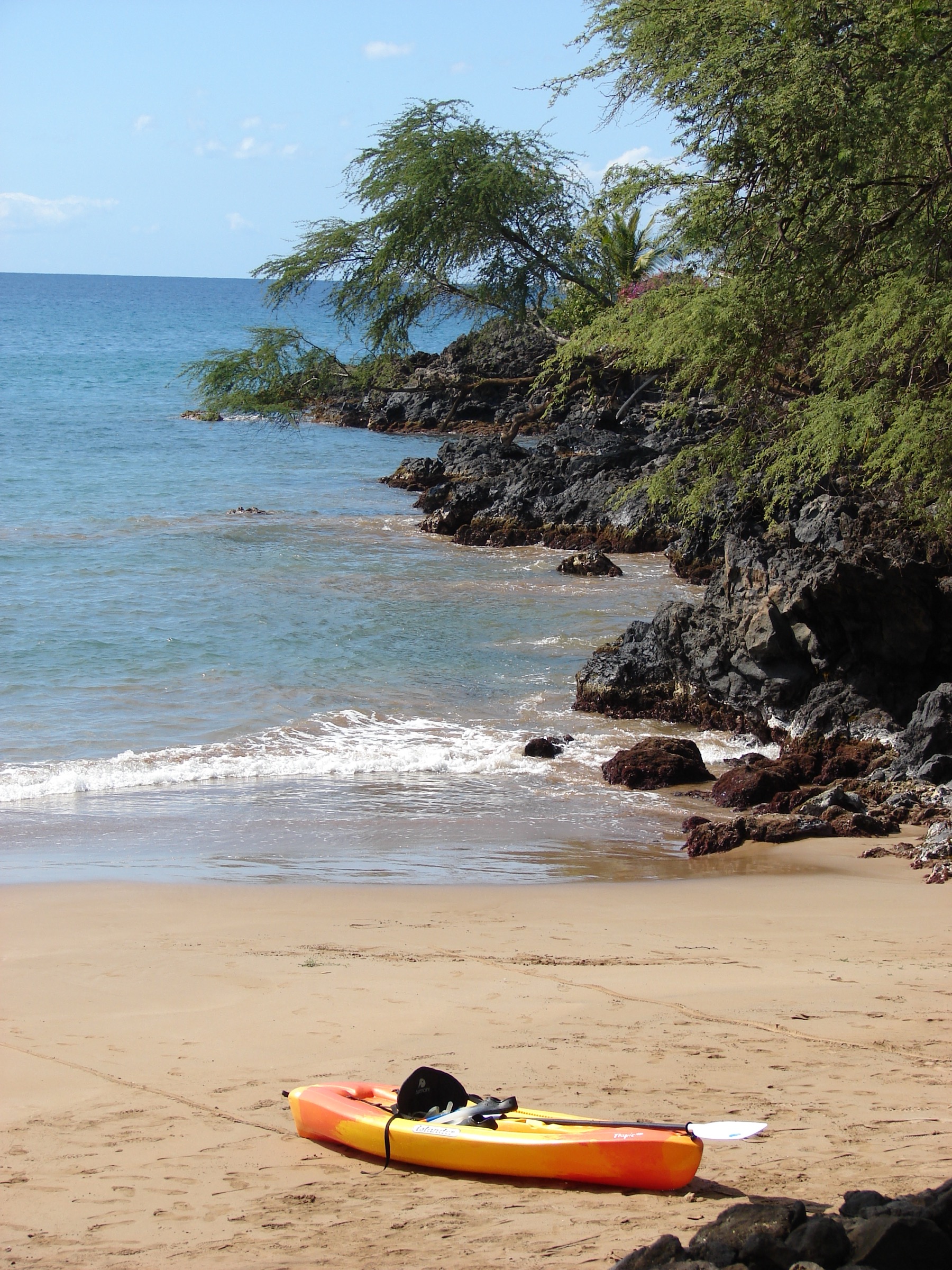 Kayak and coastal vegetation at Mākena Landing