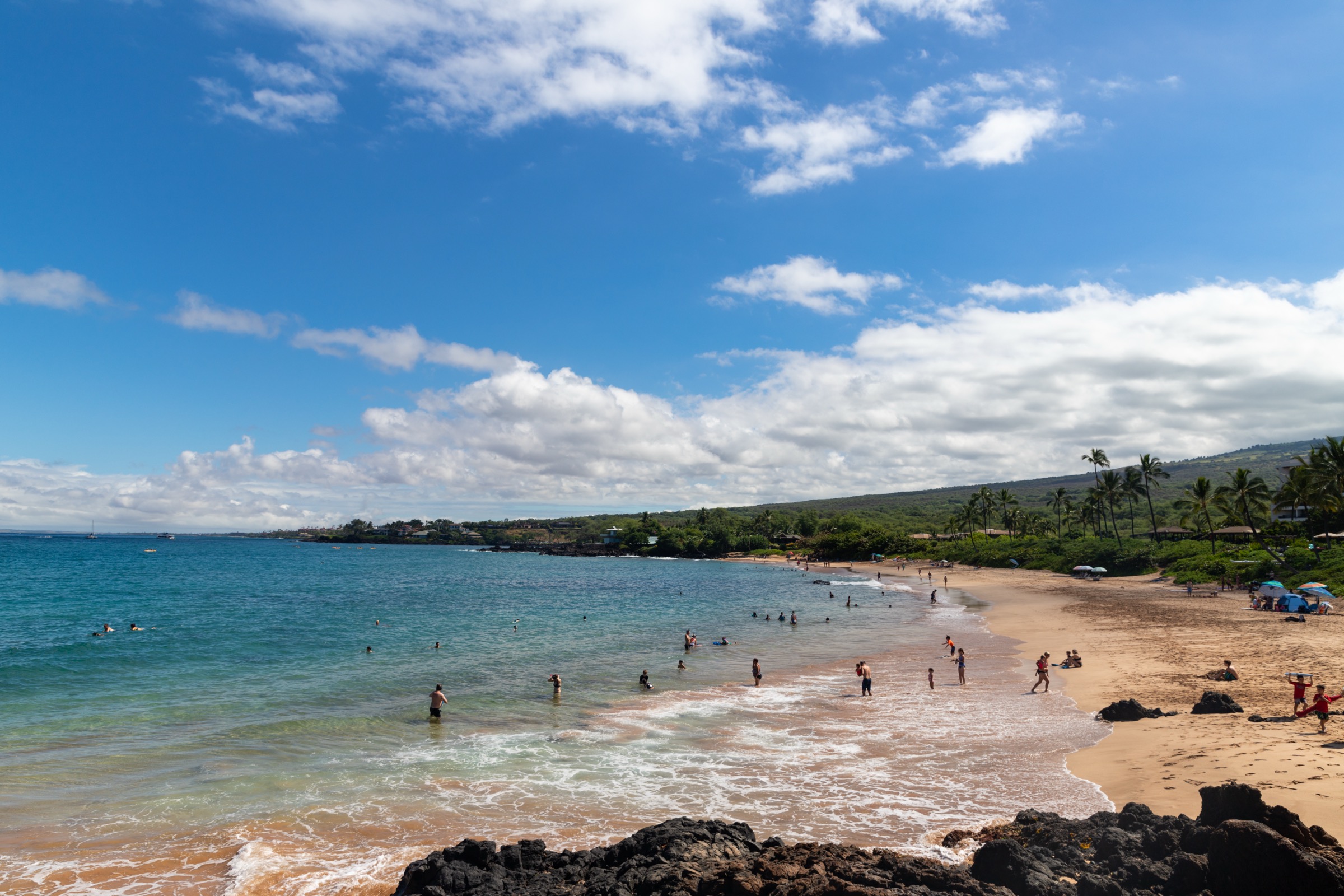Sand, palms and blue water at Maluaka Beach